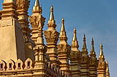 Vientiane, Laos - Surrounded by a cluster of pointed minor stupas the huge Pha That Luang shined under the warm light of the sunset. 